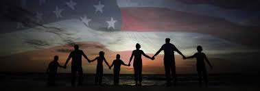 picture of people standing in front of US flag, holding hands